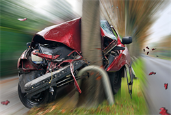Photo of automobile crashing into a pole.