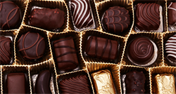 Photo of open box of chocolates.
