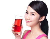 Asian girl drinking cranberry juice.
