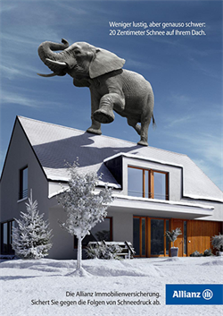 Advertising poster of elephant standing on roof of house.