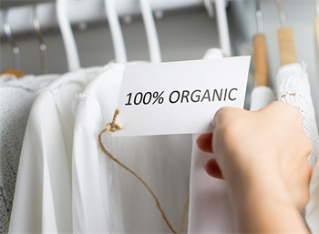 Person reading tag "100% Organic"