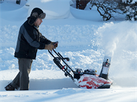 Man operating snowblower