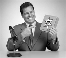 Photo of mock-up television commercial with smiling announcer pointing to a box of "Zip."