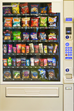 Photo of a vending machine filled with snacks.