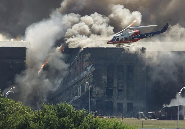 A rescue helicopter in front of where a plane crashed into the Pentagon