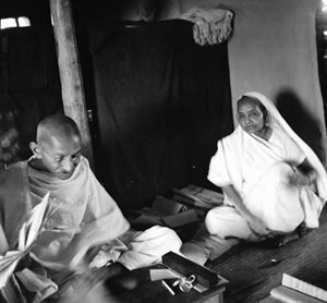 Gandhi and Kasturba, seated