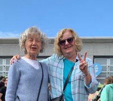 Marlene Epp and friend, making the 'peace sign' (fingers in the shape of a V)