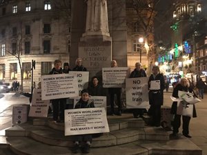 Women in Black group doing a silent protest by a war memorial in London